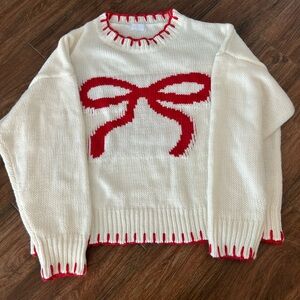 Cream Sweater with Red Bow Design